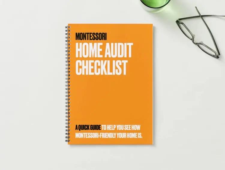 Montessori Home Audit Checklist book on a white surface with glasses and a green container in the background.