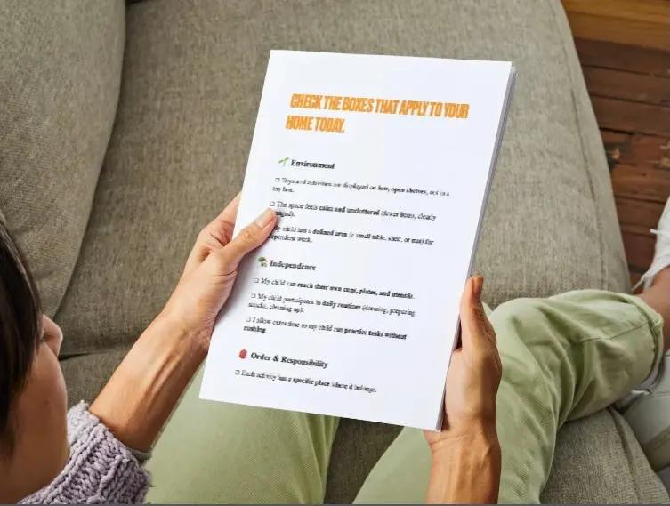 Person sitting on a couch holding a printed questionnaire.